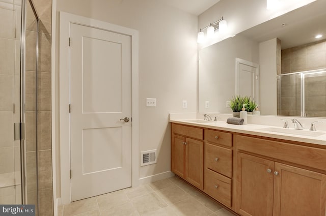 43792 Middleway Ter, Ashburn, VA 20147 - bathroom featuring double vanity, tile patterned flooring, and a shower stall