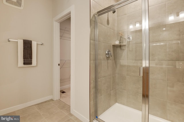 43792 Middleway Ter, Ashburn, VA 20147 - bathroom featuring a shower stall, a walk in closet, and tile patterned flooring