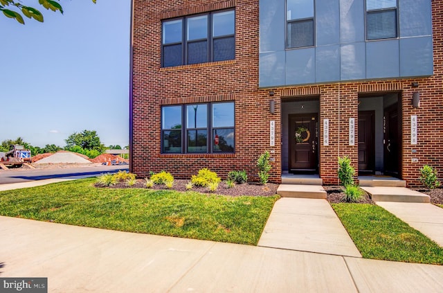43792 Middleway Ter, Ashburn, VA 20147 - view of property featuring brick siding and a front lawn