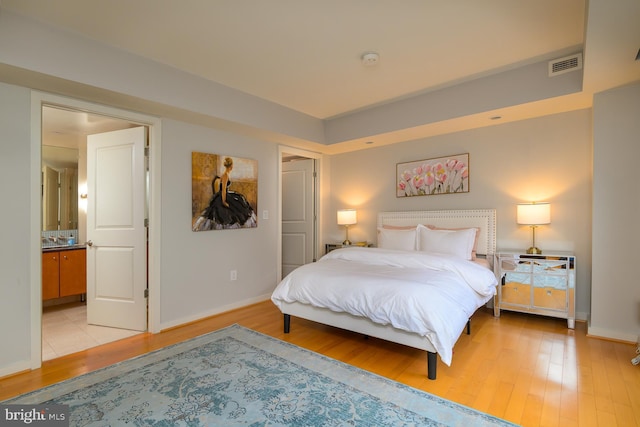 1025 1st St SE Unit 713, Washington, DC 20003 - bedroom featuring light wood-style floors and ensuite bathroom