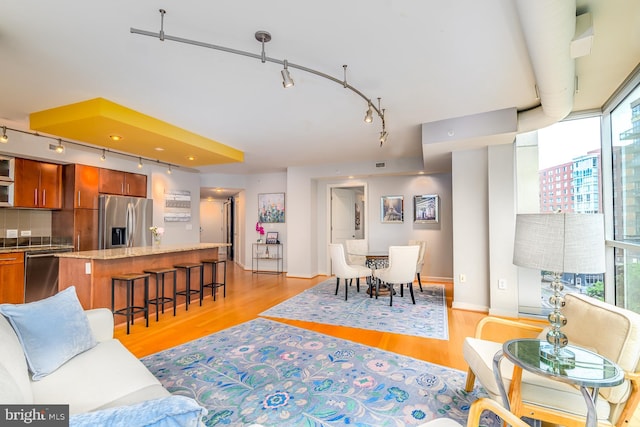 1025 1st St SE Unit 713, Washington, DC 20003 - living area with rail lighting and light wood-style flooring