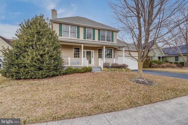 14 Doolin Ln, Rehoboth Beach, DE 19971 - view of front of property with driveway, a porch, a chimney, an attached garage, and a front yard