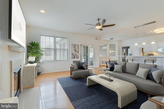 14 Doolin Ln, Rehoboth Beach, DE 19971 - living room with ceiling fan, light wood-style flooring, a fireplace with flush hearth, and recessed lighting