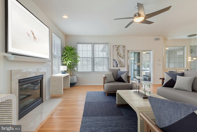 14 Doolin Ln, Rehoboth Beach, DE 19971 - living area with light wood-style floors, a high end fireplace, a ceiling fan, and recessed lighting