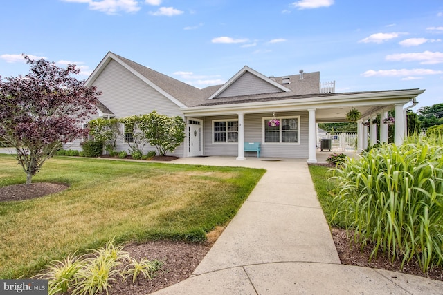 14 Doolin Ln, Rehoboth Beach, DE 19971 - view of front of home featuring a front lawn, roof with shingles, and covered porch