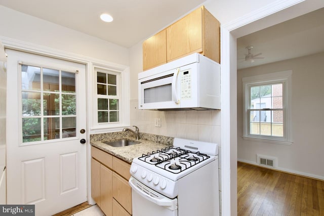 6016 N Kings Hwy, Alexandria, VA 22303 - kitchen featuring white appliances, light stone counters, ceiling fan, decorative backsplash, and light wood-type flooring