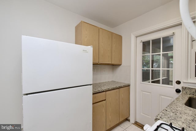 6016 N Kings Hwy, Alexandria, VA 22303 - kitchen with freestanding refrigerator, light brown cabinets, light stone countertops, and light tile patterned flooring