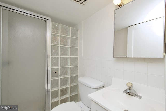 6016 N Kings Hwy, Alexandria, VA 22303 - bathroom featuring a stall shower, tile walls, vanity, and tasteful backsplash