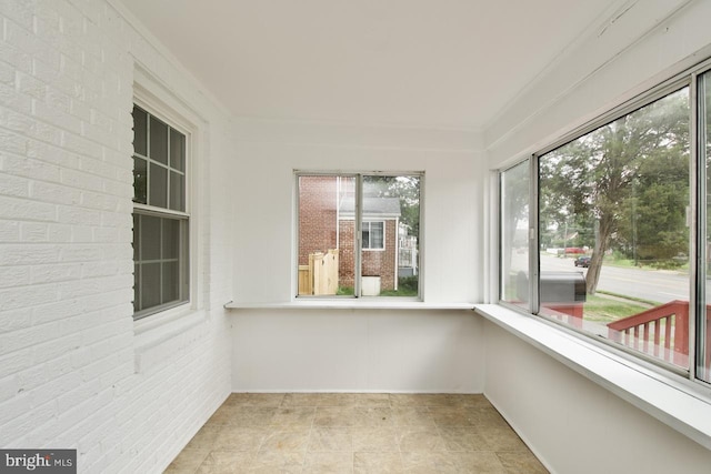 6016 N Kings Hwy, Alexandria, VA 22303 - unfurnished sunroom featuring brick wall and ornamental molding