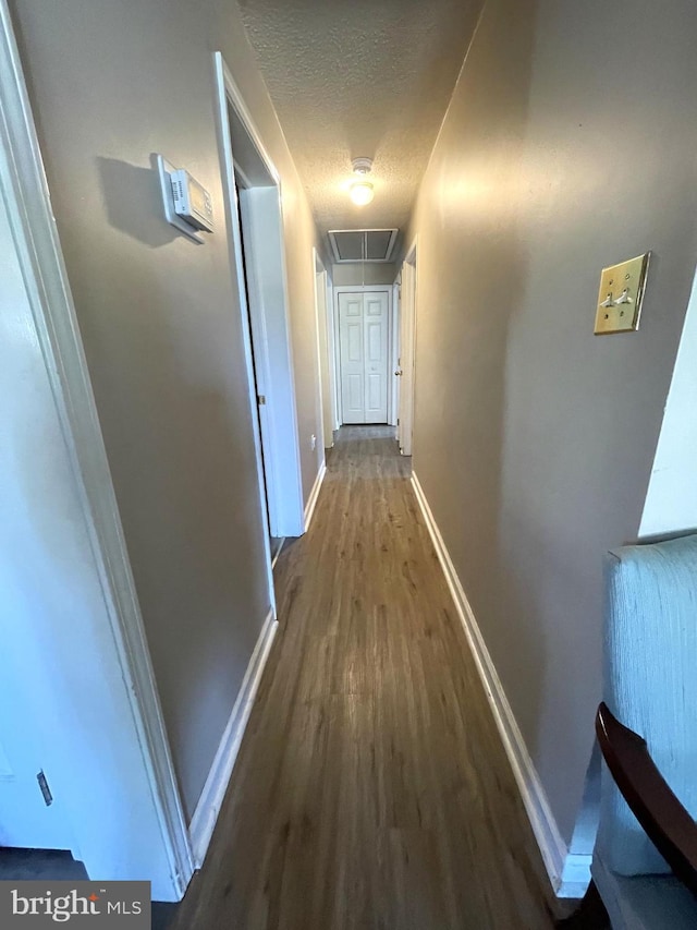 103 N W St, Harrington, DE 19952 - hall with attic access, wood finished floors, and a textured ceiling