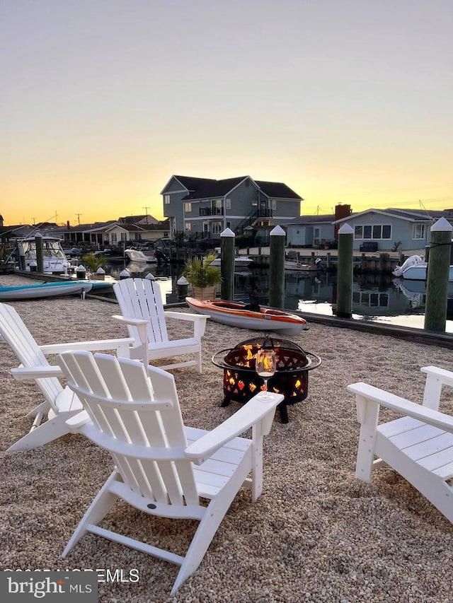 813 Forepeak Dr, Forked River, NJ 08731 - yard at dusk with an outdoor fire pit, a water view, a dock, and a residential view