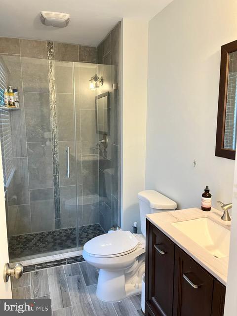 813 Forepeak Dr, Forked River, NJ 08731 - bathroom featuring vanity, a stall shower, and wood finished floors