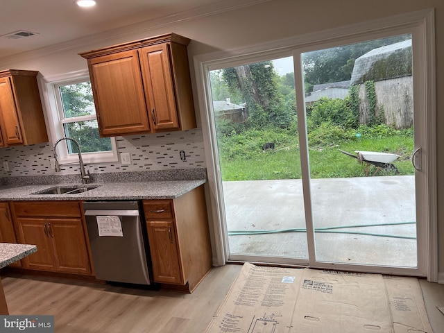 14503 Melbourne Ave, Woodbridge, VA 22191 - kitchen featuring stainless steel dishwasher, light wood-type flooring, ornamental molding, and tasteful backsplash