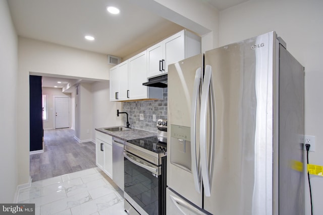 3549 Horton Ave, Baltimore, MD 21225 - kitchen featuring stainless steel appliances, under cabinet range hood, light marble finish floors, recessed lighting, and white cabinets