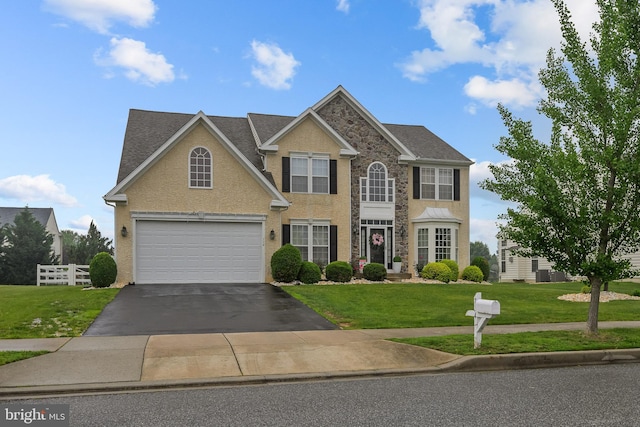 734 Wood Duck Ct, Middletown, DE 19709 - view of front facade featuring driveway, a front lawn, stucco siding, and stone siding