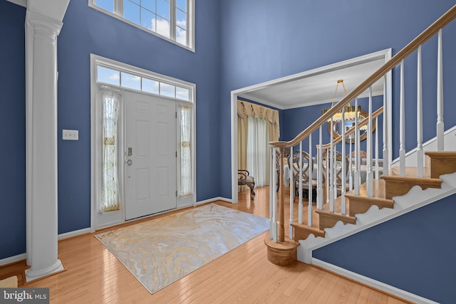 734 Wood Duck Ct, Middletown, DE 19709 - foyer entrance featuring ornate columns, stairway, a high ceiling, and hardwood / wood-style flooring