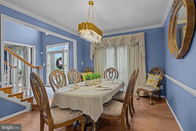 734 Wood Duck Ct, Middletown, DE 19709 - dining space with a chandelier, wood finished floors, ornamental molding, and stairs