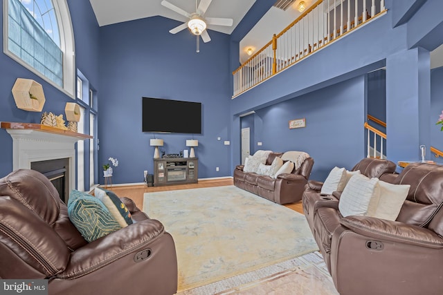 734 Wood Duck Ct, Middletown, DE 19709 - living area with high vaulted ceiling, a glass covered fireplace, ceiling fan, and wood finished floors