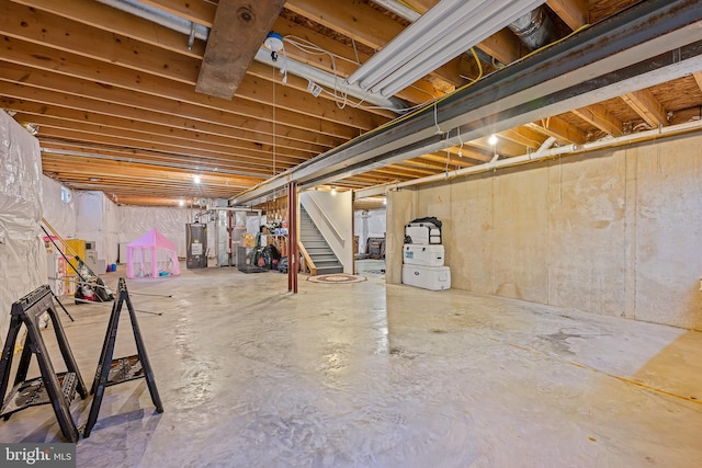 734 Wood Duck Ct, Middletown, DE 19709 - unfinished basement featuring water heater and stairway