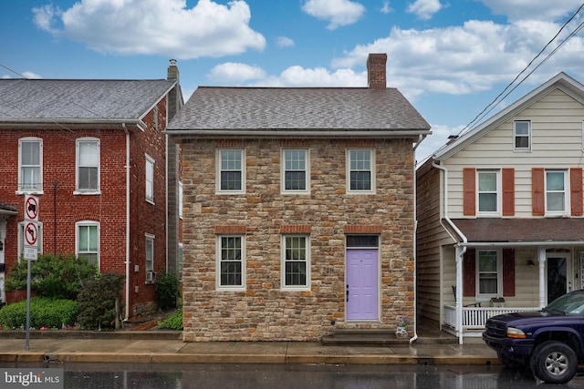 246 Marietta Ave, Mount Joy, PA 17552 - view of front of property with stone siding, a chimney, roof with shingles, and a porch