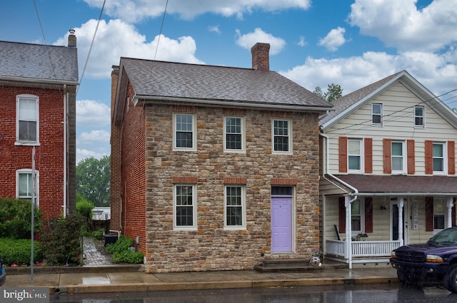 246 Marietta Ave, Mount Joy, PA 17552 - view of front of house with stone siding, a porch, a chimney, and a shingled roof