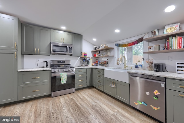 246 Marietta Ave, Mount Joy, PA 17552 - kitchen with stainless steel appliances, open shelves, gray cabinets, light wood finished floors, and vaulted ceiling