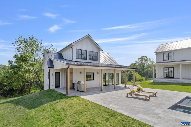 310 Goodloe Ln, Afton, VA 22920 - rear view of property with a standing seam roof, a yard, a patio, a metal roof, and board and batten siding