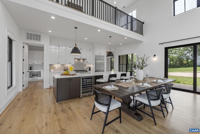 310 Goodloe Ln, Afton, VA 22920 - dining area with wine cooler, light wood-type flooring, plenty of natural light, recessed lighting, and a high ceiling