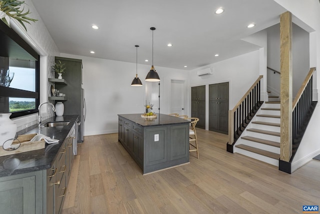 310 Goodloe Ln, Afton, VA 22920 - kitchen with a wall unit AC, open shelves, light wood-type flooring, recessed lighting, and a breakfast bar area