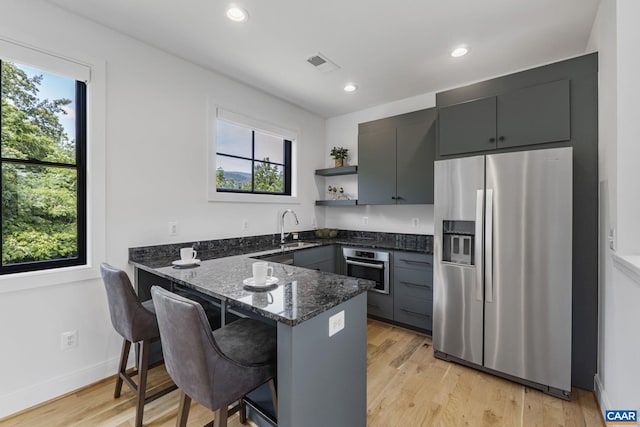 310 Goodloe Ln, Afton, VA 22920 - kitchen featuring appliances with stainless steel finishes, dark stone countertops, a peninsula, healthy amount of natural light, and recessed lighting