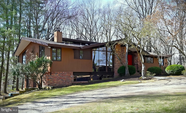 709 Springloch Rd, Silver Spring, MD 20904 - view of front of house featuring a chimney, brick siding, and a front lawn