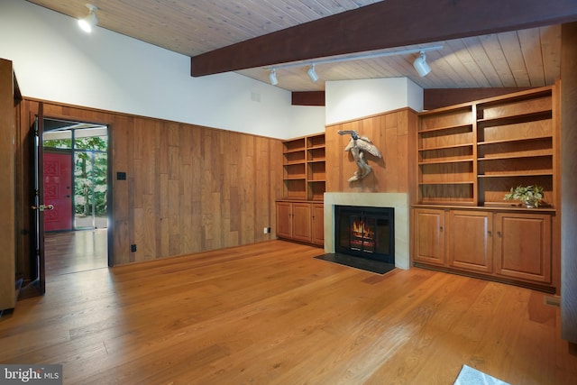709 Springloch Rd, Silver Spring, MD 20904 - unfurnished living room featuring wooden walls, a fireplace with flush hearth, light wood-style floors, wood ceiling, and track lighting