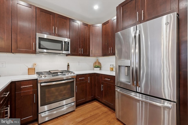 1222 N Orkney St Unit 1, Philadelphia, PA 19122 - kitchen featuring appliances with stainless steel finishes, light wood-type flooring, light countertops, and tasteful backsplash