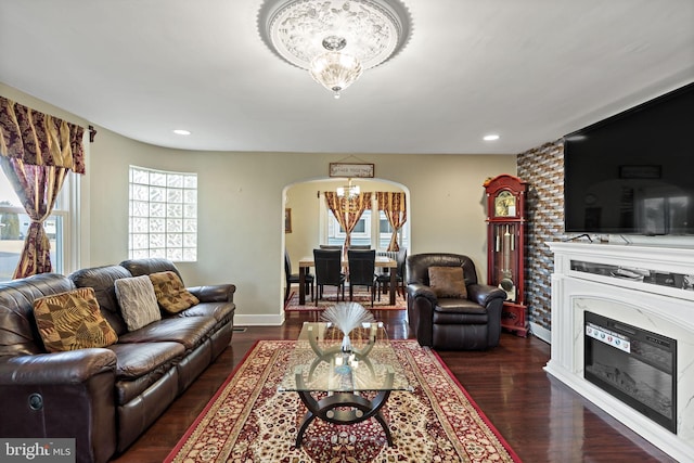 34 Harvard Rd, Hagerstown, MD 21742 - living area with a chandelier, arched walkways, wood finished floors, a glass covered fireplace, and recessed lighting