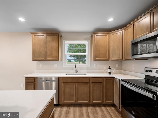 564 Great Oak Ct, Woodstock, VA 22664 - kitchen featuring appliances with stainless steel finishes, light wood-style floors, recessed lighting, light countertops, and brown cabinetry