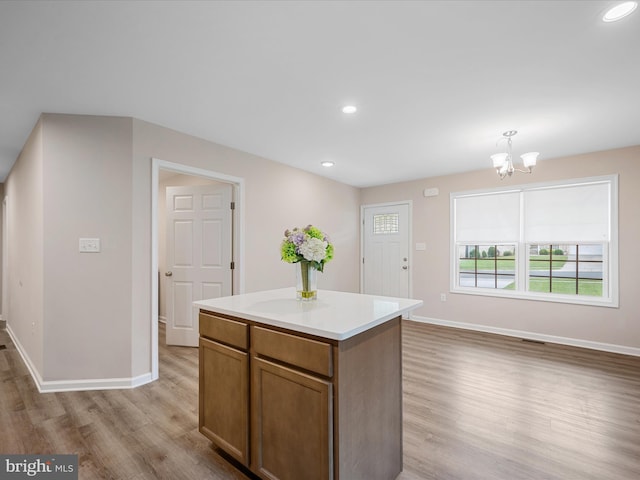 564 Great Oak Ct, Woodstock, VA 22664 - kitchen featuring light wood-type flooring, a chandelier, a kitchen island, recessed lighting, and light countertops