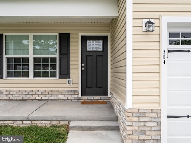 564 Great Oak Ct, Woodstock, VA 22664 - view of exterior entry featuring a porch and a garage