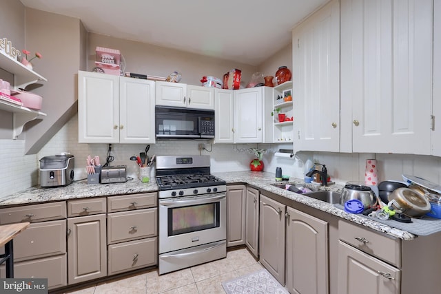 305 N Market St, Elizabethtown, PA 17022 - kitchen with gas range, black microwave, open shelves, decorative backsplash, and white cabinets
