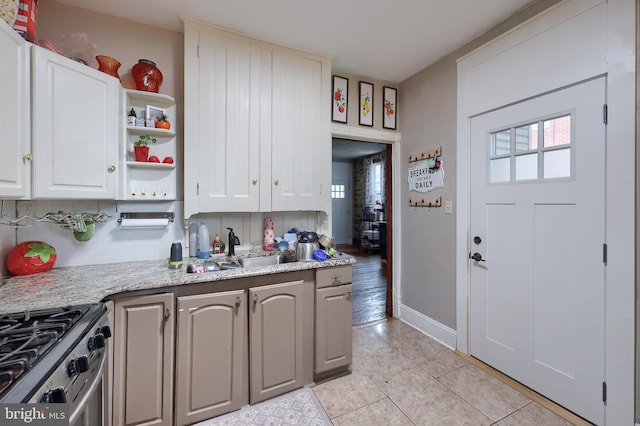 305 N Market St, Elizabethtown, PA 17022 - kitchen with light tile patterned floors, open shelves, white cabinetry, stainless steel range with gas stovetop, and tasteful backsplash