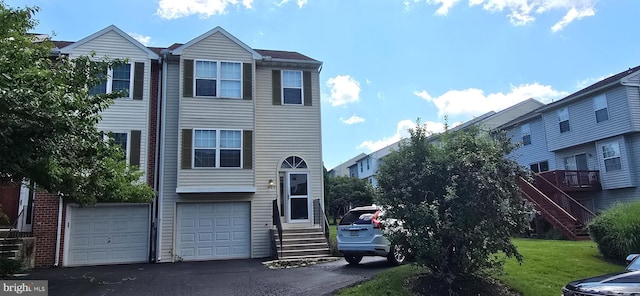 309 Lincoln Ave, Harrisburg, PA 17111 - multi unit property with an attached garage, asphalt driveway, a front lawn, and entry steps
