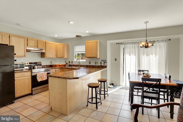 309 Lincoln Ave, Harrisburg, PA 17111 - kitchen featuring appliances with stainless steel finishes, under cabinet range hood, light brown cabinetry, dark countertops, and recessed lighting
