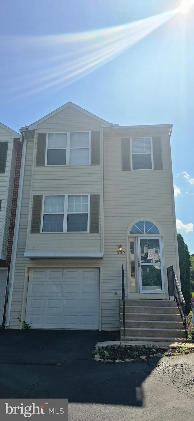 309 Lincoln Ave, Harrisburg, PA 17111 - view of front of house with a garage, asphalt driveway, and entry steps