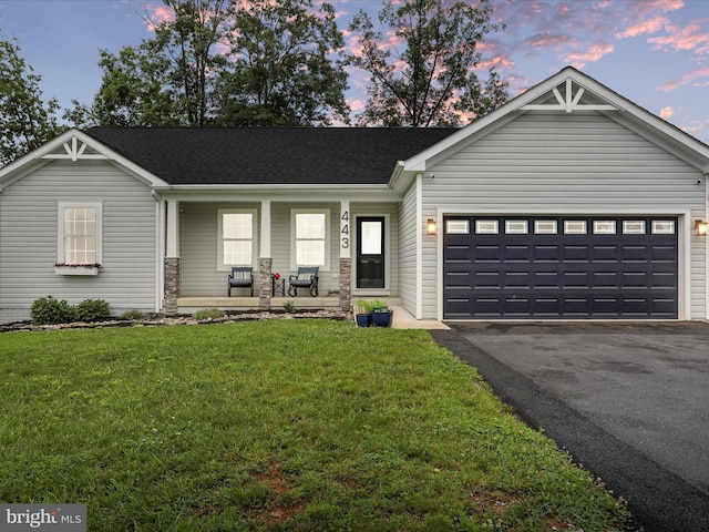 443 Executive Way, Hedgesville, WV 25427 - view of front of house with a porch, asphalt driveway, a garage, a front yard, and roof with shingles