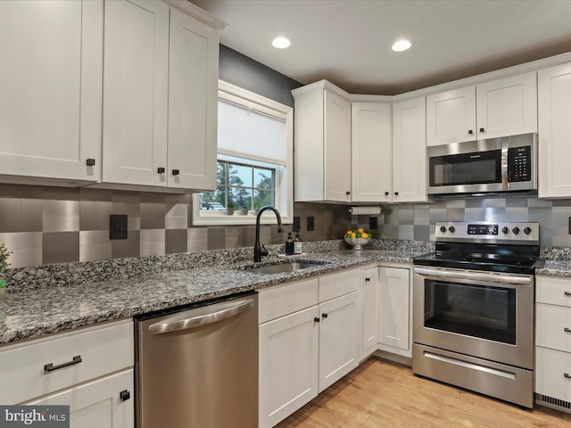 443 Executive Way, Hedgesville, WV 25427 - kitchen featuring appliances with stainless steel finishes, decorative backsplash, white cabinetry, stone countertops, and recessed lighting