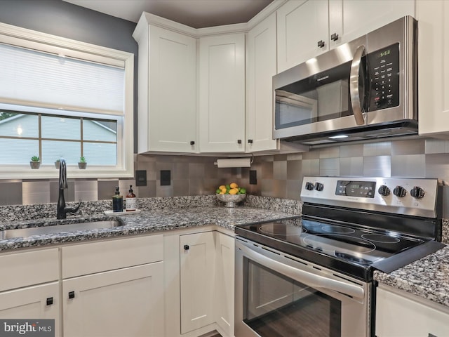 443 Executive Way, Hedgesville, WV 25427 - kitchen featuring appliances with stainless steel finishes, decorative backsplash, white cabinets, and stone countertops