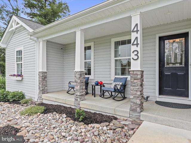 443 Executive Way, Hedgesville, WV 25427 - entrance to property with covered porch, stone siding, and a surveillance system