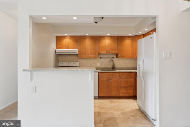 10306 Valley Forge Cir Unit 306, King Of Prussia, PA 19406 - kitchen with white appliances, under cabinet range hood, brown cabinetry, recessed lighting, and backsplash
