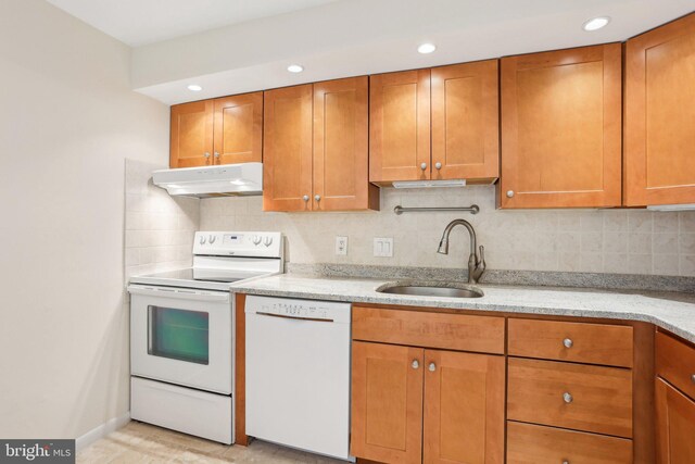 10306 Valley Forge Cir Unit 306, King Of Prussia, PA 19406 - kitchen featuring white appliances, under cabinet range hood, brown cabinets, light stone countertops, and recessed lighting