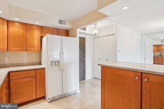 10306 Valley Forge Cir Unit 306, King Of Prussia, PA 19406 - kitchen with white fridge with ice dispenser, a chandelier, brown cabinetry, decorative backsplash, and recessed lighting