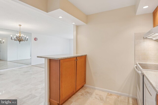 10306 Valley Forge Cir Unit 306, King Of Prussia, PA 19406 - kitchen with electric stove, a chandelier, brown cabinets, under cabinet range hood, and light stone countertops